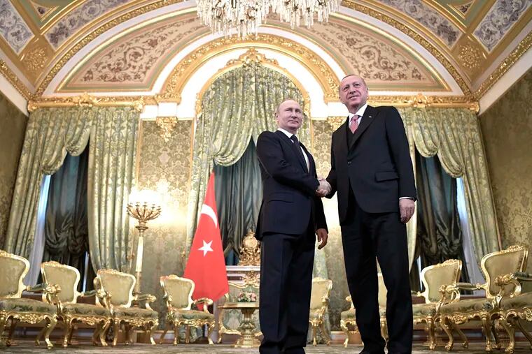 Russian President Vladimir Putin, left, and Turkish President Recep Tayyip Erdogan shake hands during their meeting in the Kremlin in Moscow, Russia, Monday, April 8, 2019. The talks are expected to focus on the situation in Syria, where the two countries have closely coordinated their steps. (Alexei Nikolsky, Sputnik, Kremlin Pool Photo via AP)
