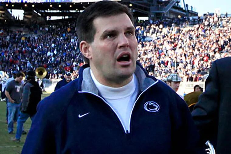 A tearful Jay Paterno, Joe Paterno's son, is escorted from the field after Penn State's loss on Saturday. (David Swanson/Staff Photographer)
