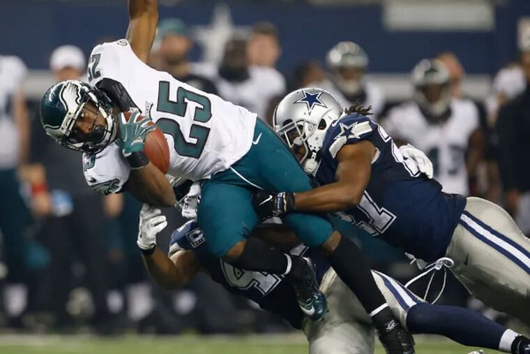 LeSean McCoy is tackled by the Cowboys' defense in the Eagles 33-10 win in Arlington. (Yong Kim/Staff Photographer)