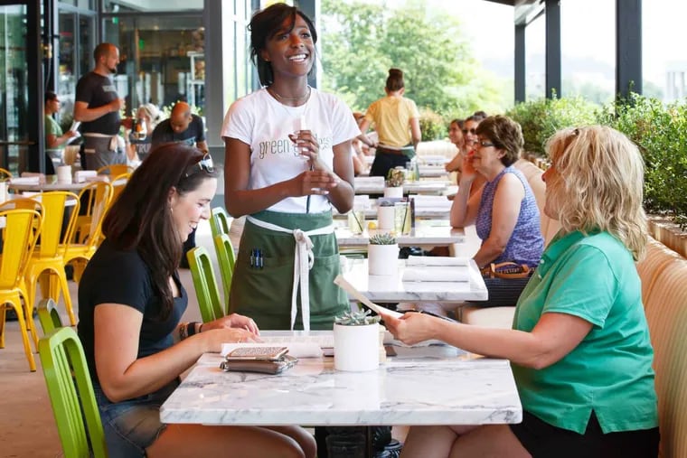Lacey Hamilton (left) and her mother, Joy Lott, listen to server Eonnah McKenzie describe menu options, at True Food Kitchen, located along Mall Blvd next to the King of Prussia Mall.