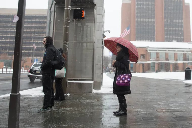 Morning commuters wait to cross Market Street at 5th Street in Philadelphia on January 27, 2015. (Colin Kerrigan / Philly.com)