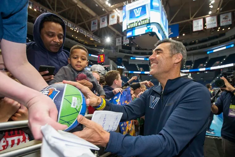 Coach Jay Wright, right, of Villanova signs autographs for a group of youths following their practice. Villanova ran through their public practice session at the XL Center in Hartford, CT on March 20, 2019 as they prepare for their game against St. Maryâ€™s in the NCAA Tournament.