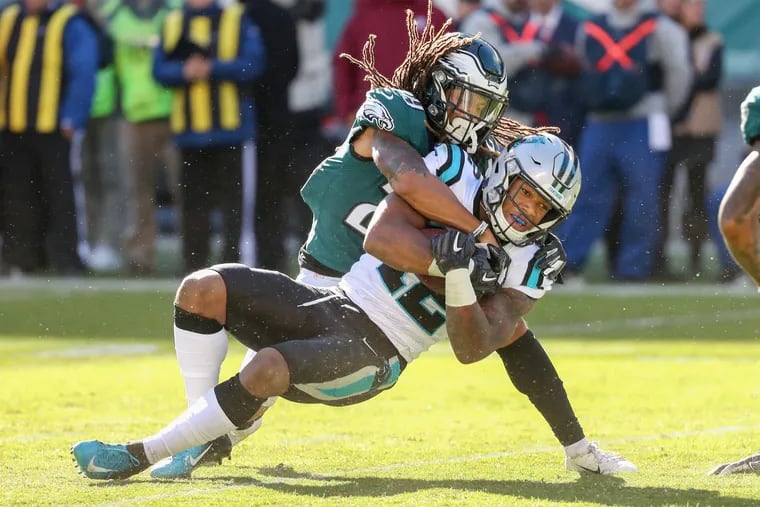 Avonte Maddox wraps up Panthers receiver D.J. Moore in the fourth quarter of Sunday's game.