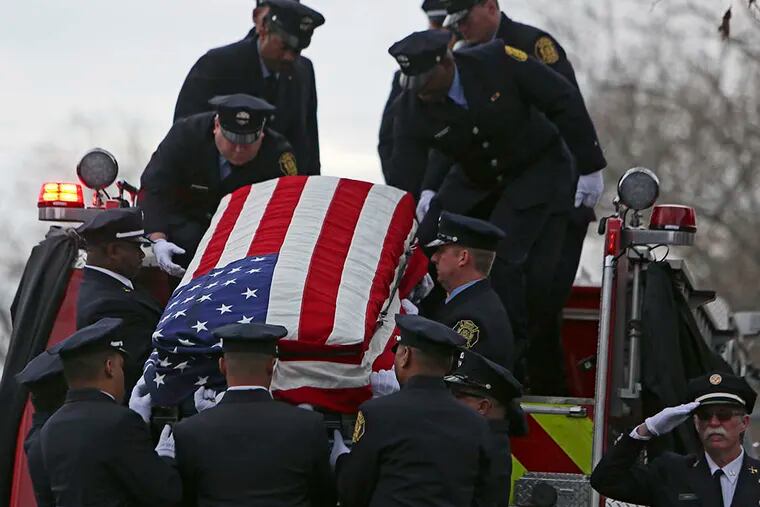 Firefighters load the casket of fallen Philadelphia firefighter Joyce Craig onto Engine 64 following her funeral service in Philadelphia on Dec. 13, 2014. ( Joseph Kaczmarek / AP Photo )