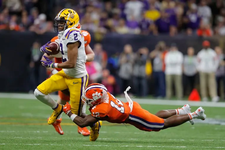 Will LSU wide receiver Justin Jefferson, shown running with the ball against Clemson in the national championship game, still be on the board for the Eagles at 21?