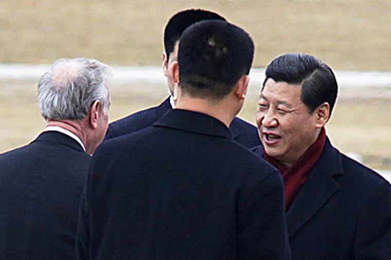 Xi Jinping (right), China's vice president, is greeted by the mayor of Davenport, Iowa, upon his arrival in the region.The man who will be China's next president returned to an area he visited 27 years ago. (Rashah McChesney / Quad-City Times)