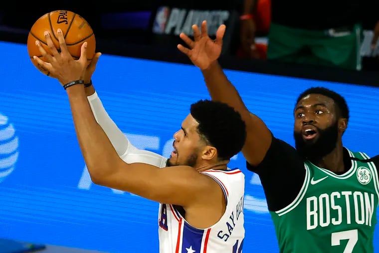Tobias Harris, left, of the Philadelphia 76ers goes up for a shot against Jaylen Brown, right, of the Boston Celtics during the first half of Game 2 of an NBA basketball first-round playoff series, Wednesday, Aug. 19, 2020, in Lake Buena Vista, Fla.