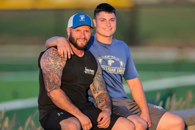 Conwell-Egan senior Gavin Pond with his father, John Pond, an assistant football coach at the school. Gavin led the Eagles in their first game at the team's new field.