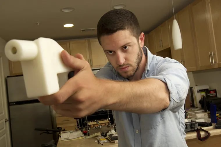 Cody Wilson shows the first completely 3D-printed handgun, The Liberator, at his home in Austin, Texas. in May.