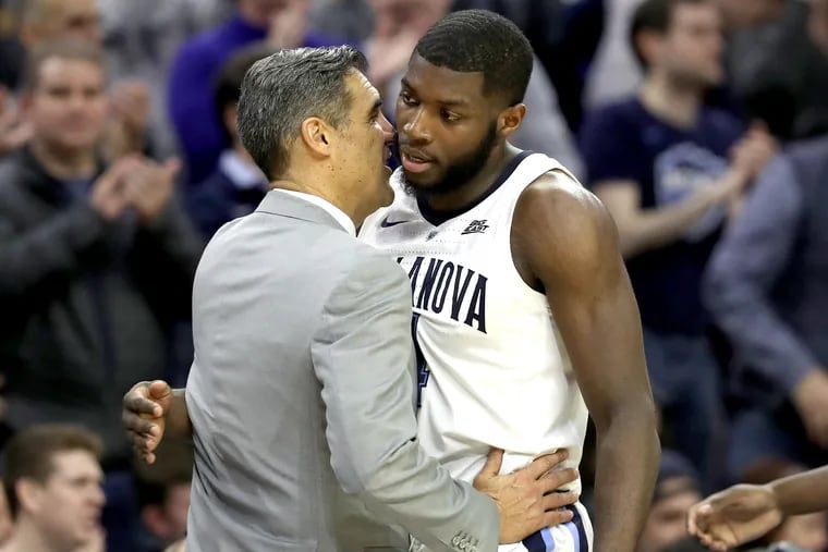 Senior Eric Paschall, right,  of Villanova and Coach Jay Wright exchange hugs as he exits his final home game.  Villanova defeated Butler at the Wells Fargo Center on March 2, 2019.
