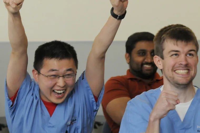 At Thomas Jefferson, Jeff Chien, emergency medicine resident, reacts to a correct answer from his team, including Brendan Leahy. (April Saul / Staff Photographer)