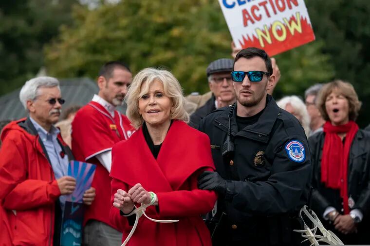 FILE - In this Friday, Oct. 25, 2019, file photo, actress and activist Jane Fonda is arrested at the Capitol for blocking the street after she and other demonstrators called on Congress for action to address climate change, in Washington. Fonda spent a night in a Washington, D.C., jail after her fourth arrest in as many weeks during a climate change demonstration on Capitol Hill. The 81-year-old Oscar winner was among more than 40 people arrested Friday, Nov. 1, while sitting inside a Senate office building. (AP Photo/J. Scott Applewhite, File)