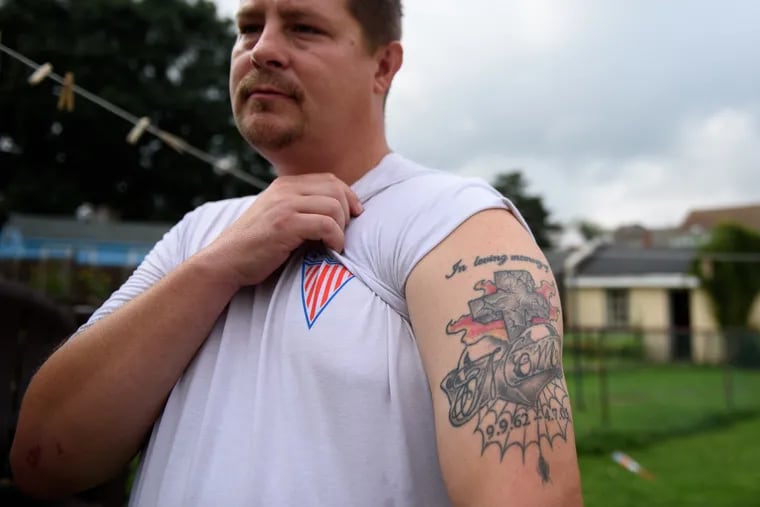 Ron Januzelli lifts his sleeve to reveal a tattoo dedicated to his mother. Marlene Januzelli died 14 years ago of a prescription overdose while being treated for an opioid addiction.