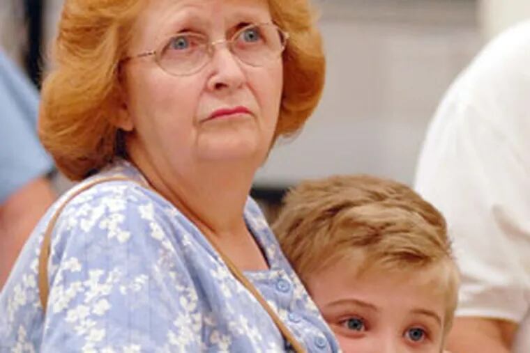 Florence DeCample of Swathmore holds her grandson Anthony Lonetti, 5, as she listens to Rendell.