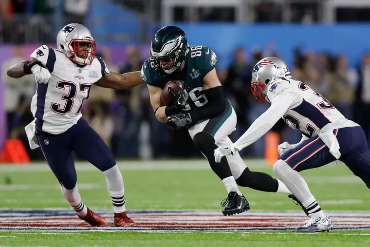 Zach Ertz tries to split Patriots defenders Jordan Richards (left) and Patrick Chung during Super Bowl 52 following the 2017 season.