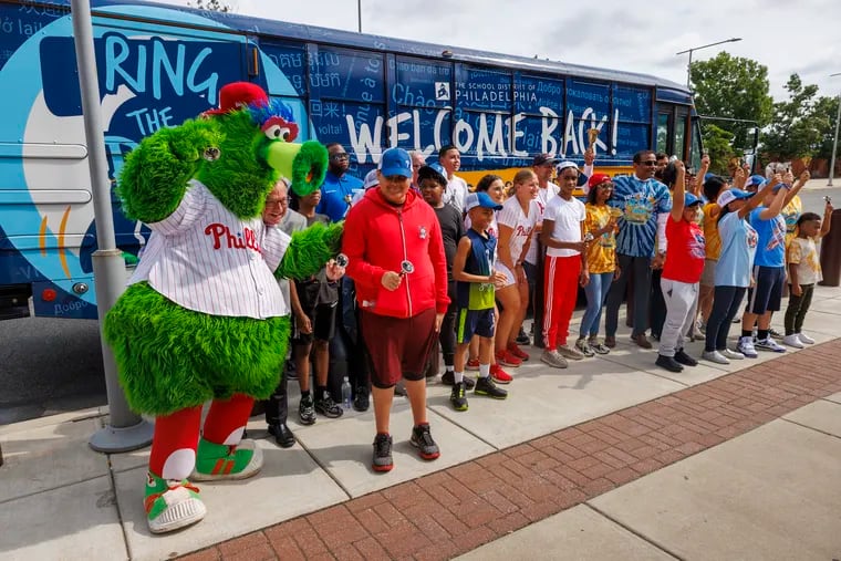 The Phillie Phanatic helped kick off the ceremonial bell-ringing for the start of the new school year beside the school district's Ring the Bell bus outside Citizens Bank Park on Monday. School is scheduled to begin for 113,000 Philadelphia School District students on Sept. 5.