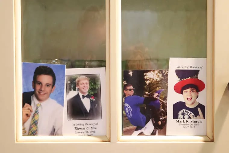 Four photos of (from left) Jimi Patrick, Tom Meo, Dean Finocchiaro, and Mark Sturgis, placed in a kitchen cabinet window in the home of the Patricks. in this file photo.
