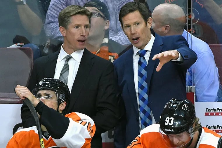 Philadelphia Flyers head coach Dave Hakstol and assistant coach Gord Murphy behind the bench against the Florida Panthers during the third period at Wells Fargo Center. The Flyers defeated the Panthers, 1-0.