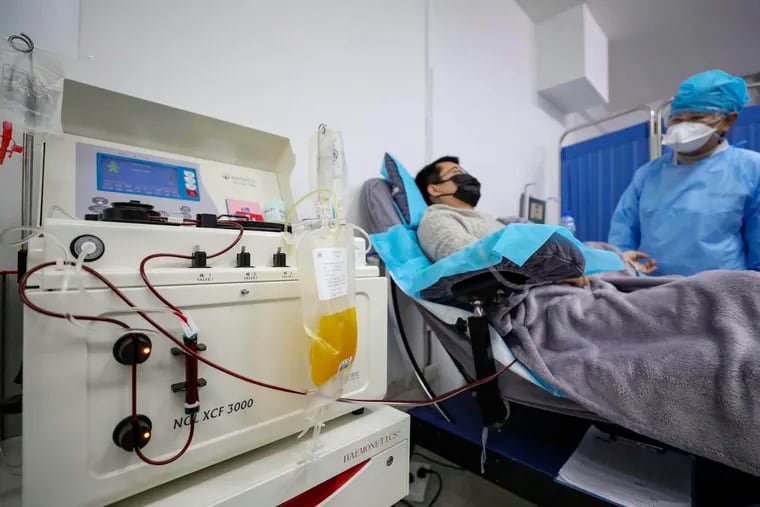 Dr. Kong Yuefeng, a recovered COVID-19 patient who has passed his 14-day quarantine, donates plasma in the city's blood center in Wuhan in central China's Hubei province on Feb. 18.