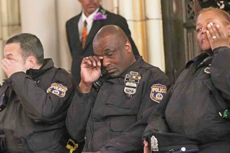 22d District police officers (from left) Brian Saba, Michael Goode, and Tanya Averette wipe away tears during the memorial Mass. 'I thought this service . . . shows there's great support for us out there,' Saba said.
Michael Bryant / Staff Photographer