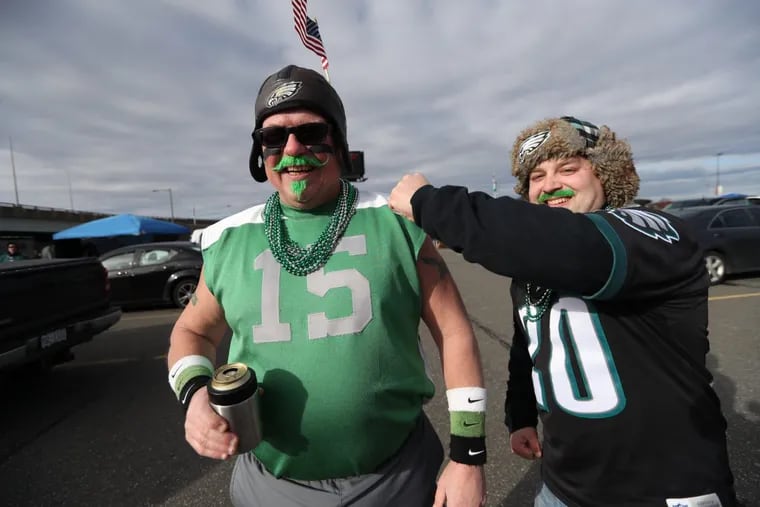 Jim Miller, of Lebanon, left, and Eric Cassel, of Annville, join in tailgating festivities ahead of the Eagles-Falcons playoffs Saturday morning.