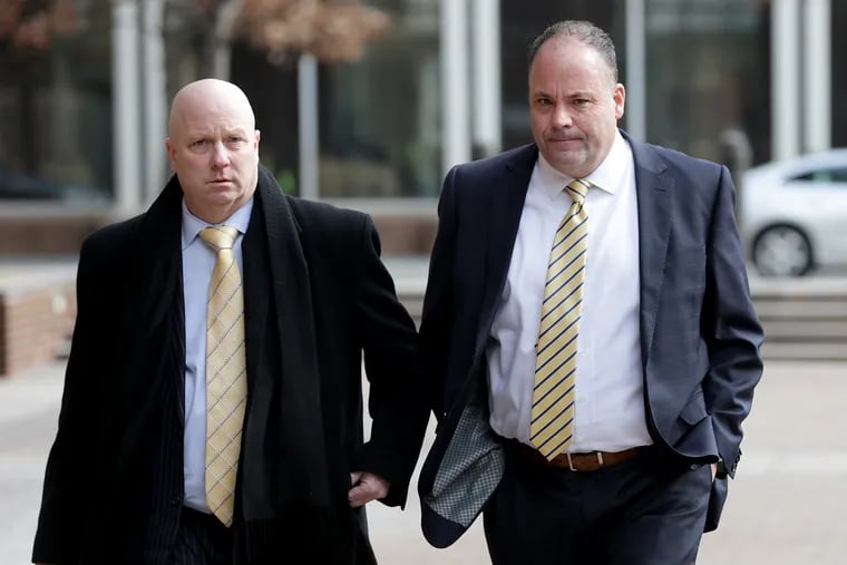 Michael Neill (right) head of the apprentice training program at Local 98 of the International Brotherhood of Electrical Workers, arriving at the federal courthouse in Center City with his attorney in February 2019.