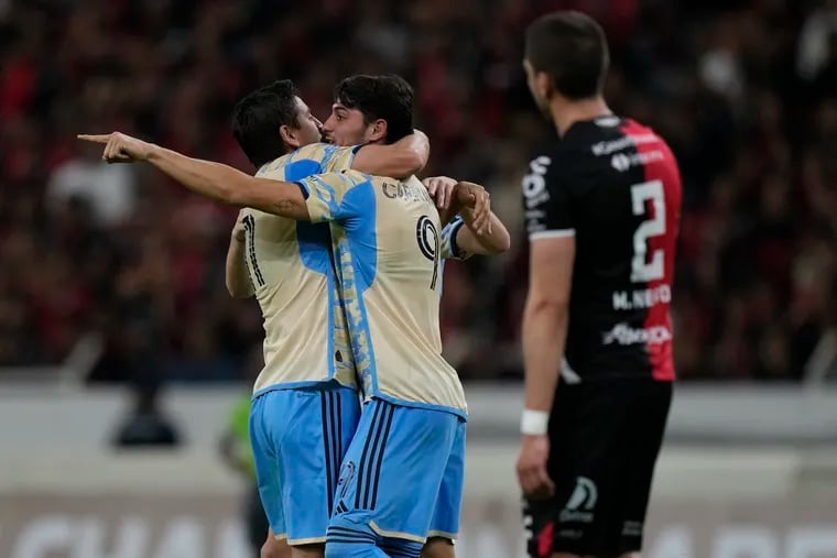 Julián Carranza (center) celebrates with Alejandro Bedoya after scoring one of his two goals Wednesday night.