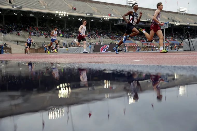 Competitors in the high school boys’ 4×800 event had to contend with a wet track as rain fell at the Penn Relays on Friday.
