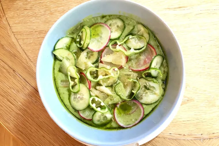 Avocado and zucchini soup at a.kitchen with shaved radishes, cucumbers, spicy Padron peppers at grated black lime.
