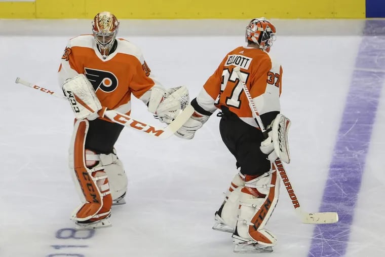Michal Neuvirth (left) replaced Brian Elliott in goal for the Flyers on Wednesday after the Penguins’ third goal.