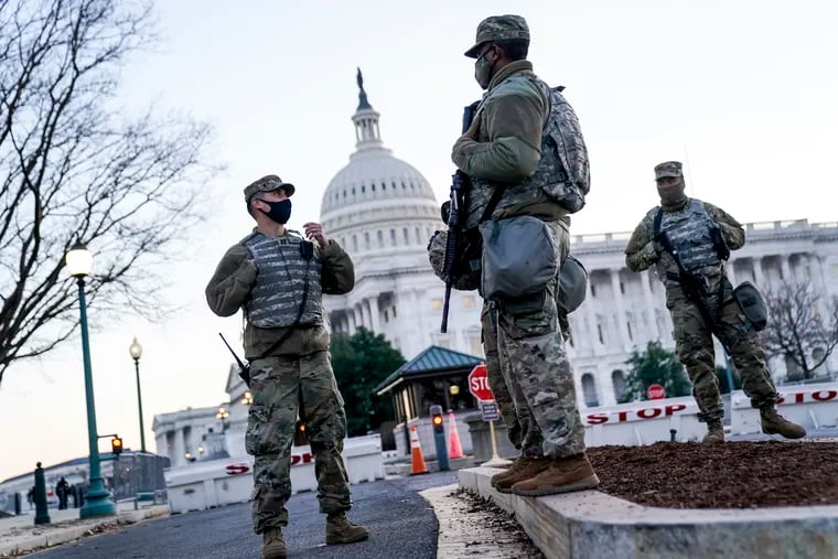 National Guard troops outside the U.S. Capitol on Capital Hill on Wednesday. The House of Representatives convened for a session to take up articles of impeachment against President Donald Trump, nearly a week after an insurrectionist mob of pro-Trump supporters breached the security of the nation's capitol while Congress voted to certify the 2020 election results.