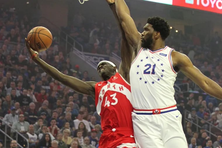 Joel Embiid, right, fouling Pascal Siakam, left, during the Sixers-Raptors playoff series in May.