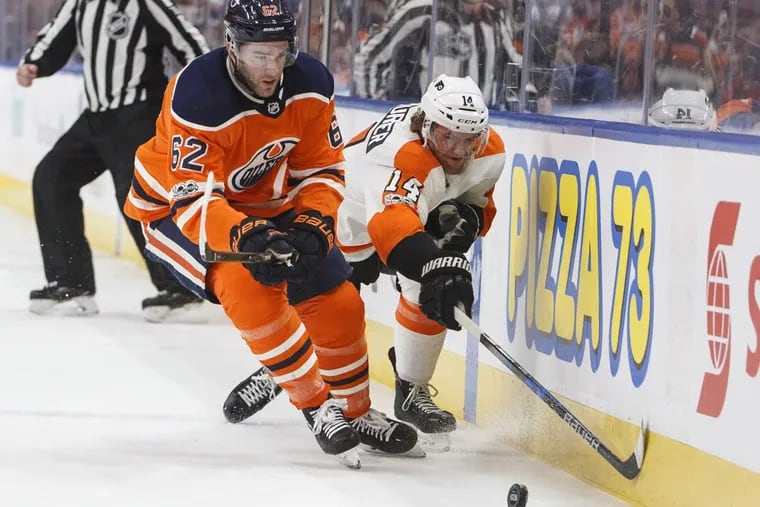 Sean Couturier and the Edmonton Oilers’ Eric Gryba vie for the puck during the first period.