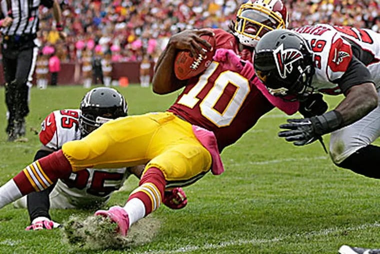 Redskins quarterback Robert Griffin III was injured on this play Sunday. (Evan Vucci/AP)
