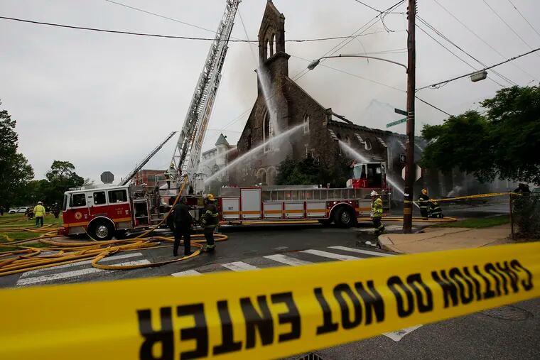 Philadelphia Firefighter's spray water on St. Leo Roman Catholic Church in the Tacony neighborhood on Sunday, May 9, 2021.  The historic church caught on fire Sunday afternoon.