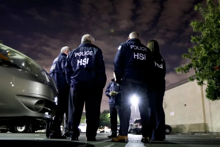 U.S. Immigration and Customs Enforcement agents gather before serving a employment audit notice at a 7-Eleven convenience store in Los Angeles earlier this month. Agents said they targeted about 100 7-Eleven stores nationwide Wednesday to open employment audits and interview workers.
