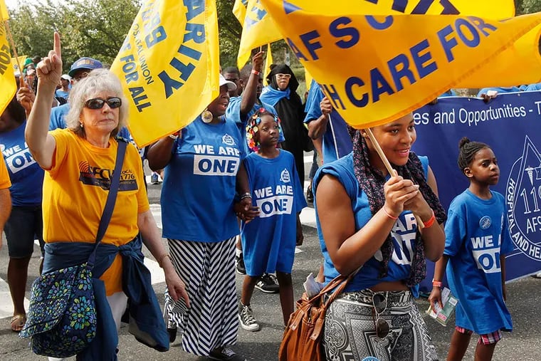 Healthcare workers march on Columbus Boulevard during the Labor Day Parade.