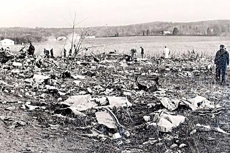 Emergency personnel sift through debris after a plane crashed in Elkton, Md. on December 8, 1963, killing 81 people. Officials blamed the crash of the Boeing 707 en route from Puerto Rico to Philadelphia on a lightning strike. (AP Photo/Cecil County Dept. of Emergency Management)