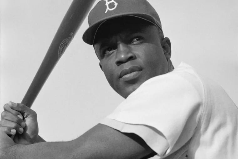 Jackie Robinson of the Brooklyn Dodgers, poised and ready to swing.
