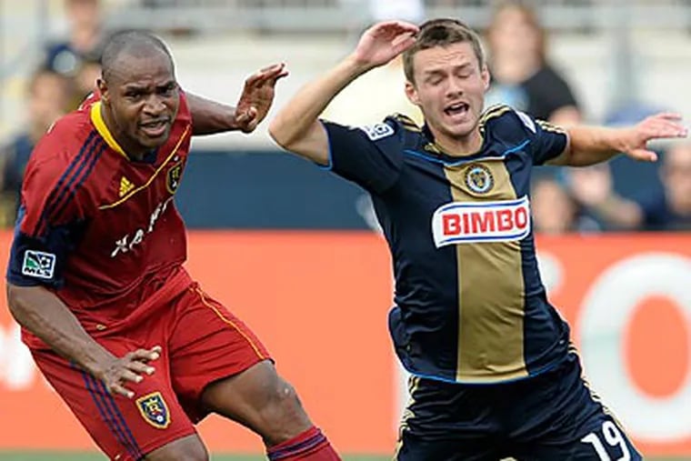 Real Salt Lake's Jamison Olave and Union midfielder Jack McInerney battle for the ball. (Michael Perez/AP)