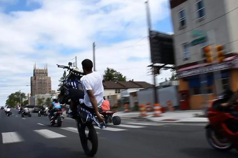 Philly Hang Gang members ride along a North Philly street on a recent Sunday.

DAVID MAIALETTI / STAFF PHOTOGRAPHER