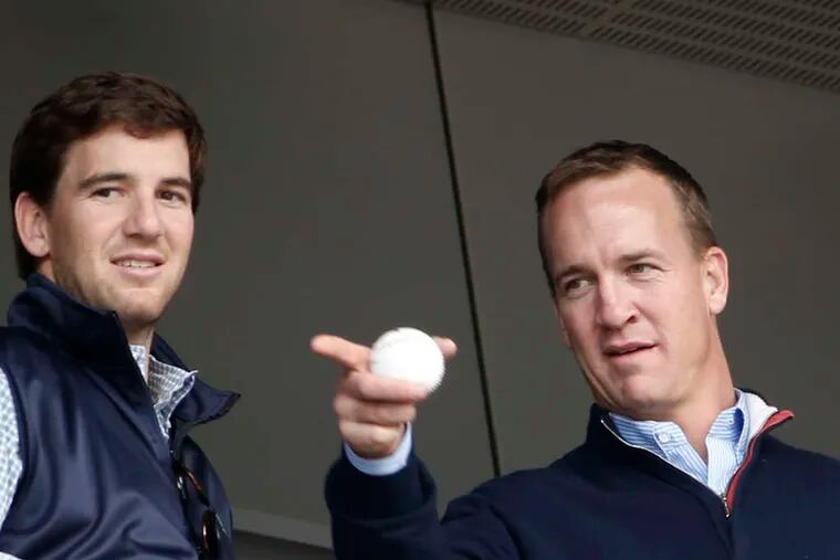 ASSOCIATED PRESS Peyton Manning, with brother Eli (left), was in New York to see Derek Jeter and the Yankees play. Said Peyton of Jeter: 'He's supported me through my career, I try to do the same for him and it's been a unique friendship.' Dodgers rightfielder Yasiel Puig collides with the wall in a failed attempt to catch a ninth-inning double in Miami.
