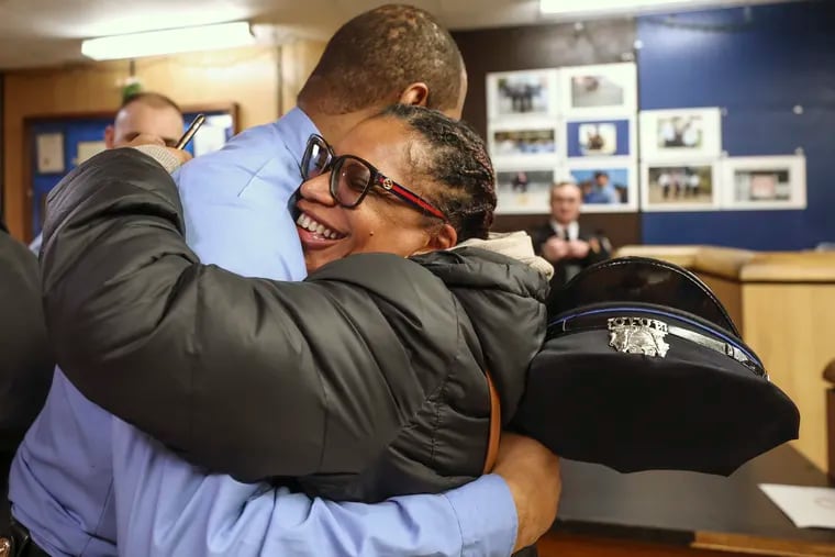 Joyce Jones hugs Officer Lamar Johnson at the 18th Police District in West Philadelphia. Johnson was one of three officers who helped save Jones when she suffered a severe asthma attack and passed out in her husband's car while they were rushing to the hospital.