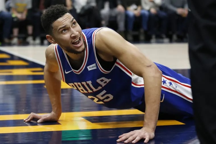 Sixers guard Ben Simmons looks up after being knock to the court in the second half against the Jazz.