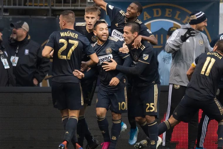 Marco Fabian (10) celebrates with teammate after scoring the winning goal for the Union against the New York Red Bulls.