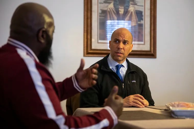 Simian Paulk, 50, of Camden, N.J., talks about his experience in the criminal justice system and his transition back to the community with United States Senator Cory Booker inside his home on Feb. 29, 2020. Paulk is one of the first from New Jersey released under the “First Step Act” that Booker help get passed. “I’m nobody, but he is showing that he cares,” Paulk said. “He’s going beyond and above the limits of helping people. I respect the man to the upmost.”