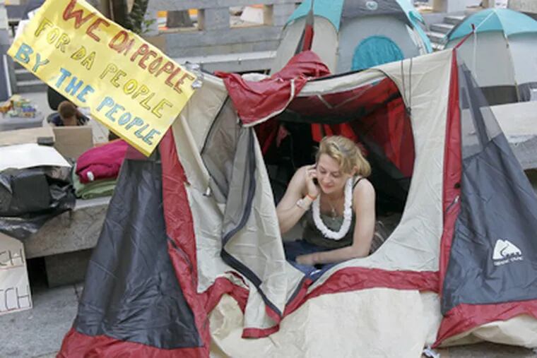 Elisabeth Levinson, from Philadelphia, sits in her tent near City Hall
Sunday for Occupy Philadelphia. (AP Photo/Alex Brandon)