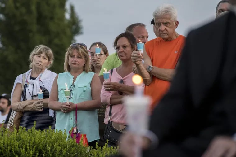 Some of the people who came to the Garden of Reflection in Lower Makefield for a prayer and candlelight vigil July 16, 2017 for four young Bucks County murder victims.