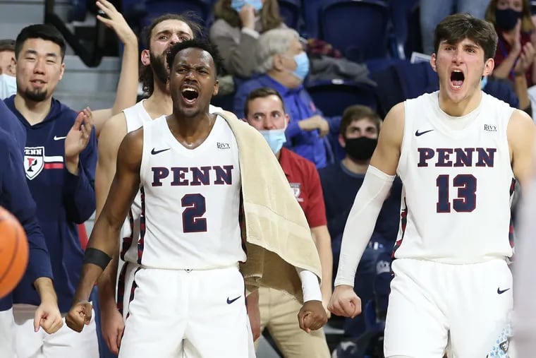 Jonah Charles (2) and Nick Spinoso (13) of Penn celebrate on the bench late in their victory over Lafayette on Nov. 16.