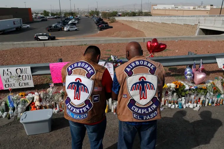 People pray a makeshift memorial for victims of a mass shooting at a shopping complex Monday, Aug. 5, 2019, in El Paso, Texas.